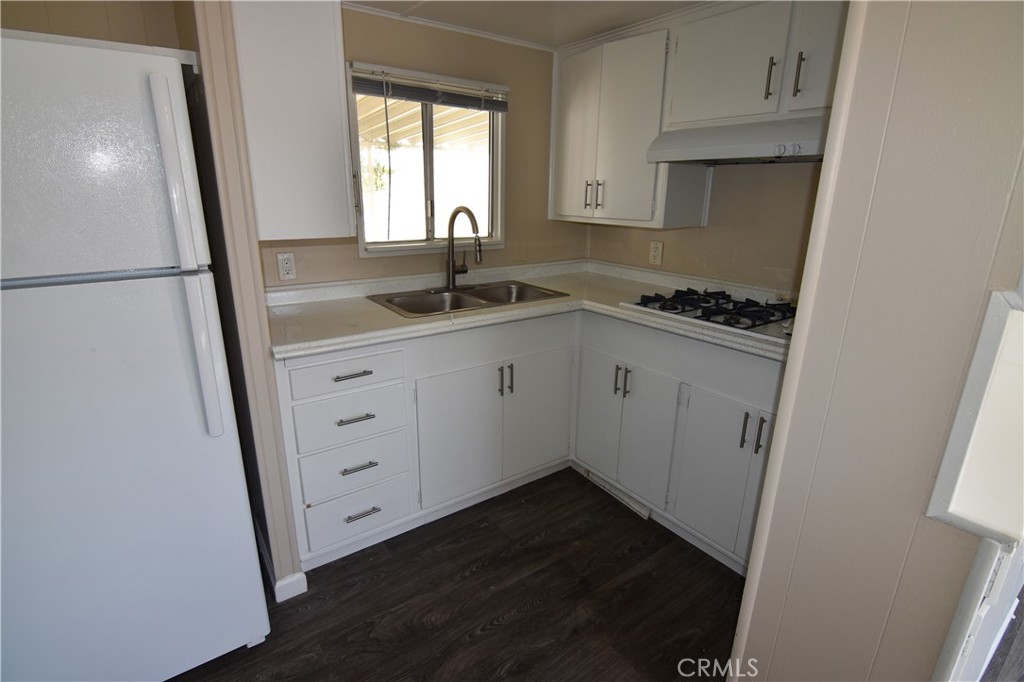 109 1st Avenue, Unit 3 Pacifica, CA 94044 - Photo 6 of 23 a kitchen with granite countertop a sink a stove and refrigerator