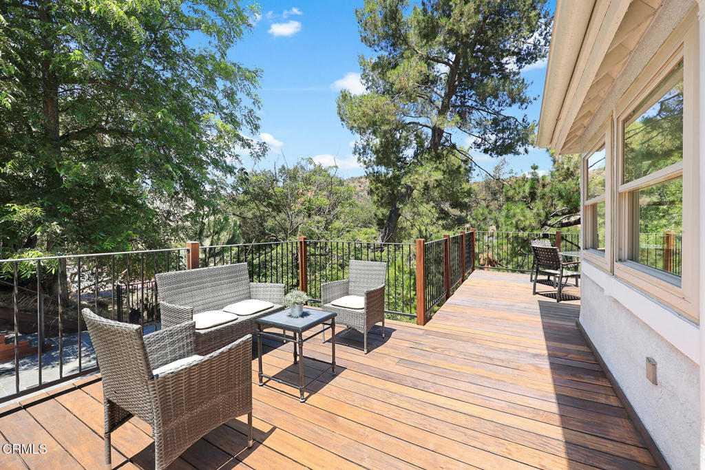 a view of a patio with couches chairs and wooden floor