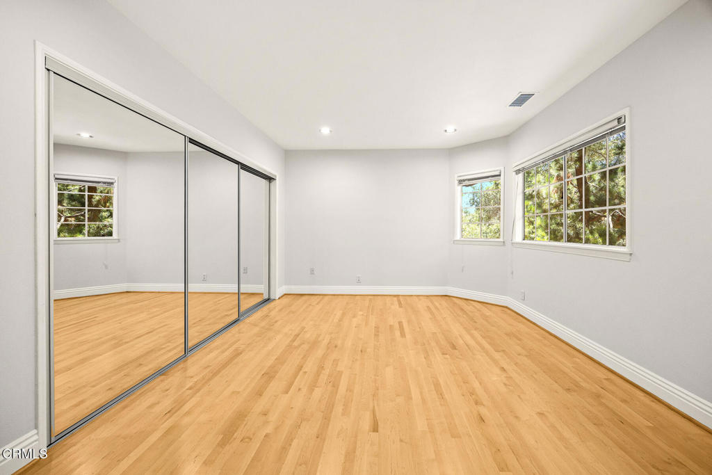 405 Woodcliffe Road Pasadena, CA 91105 - Photo 15 of 24 a view of an empty room with wooden floor and a window