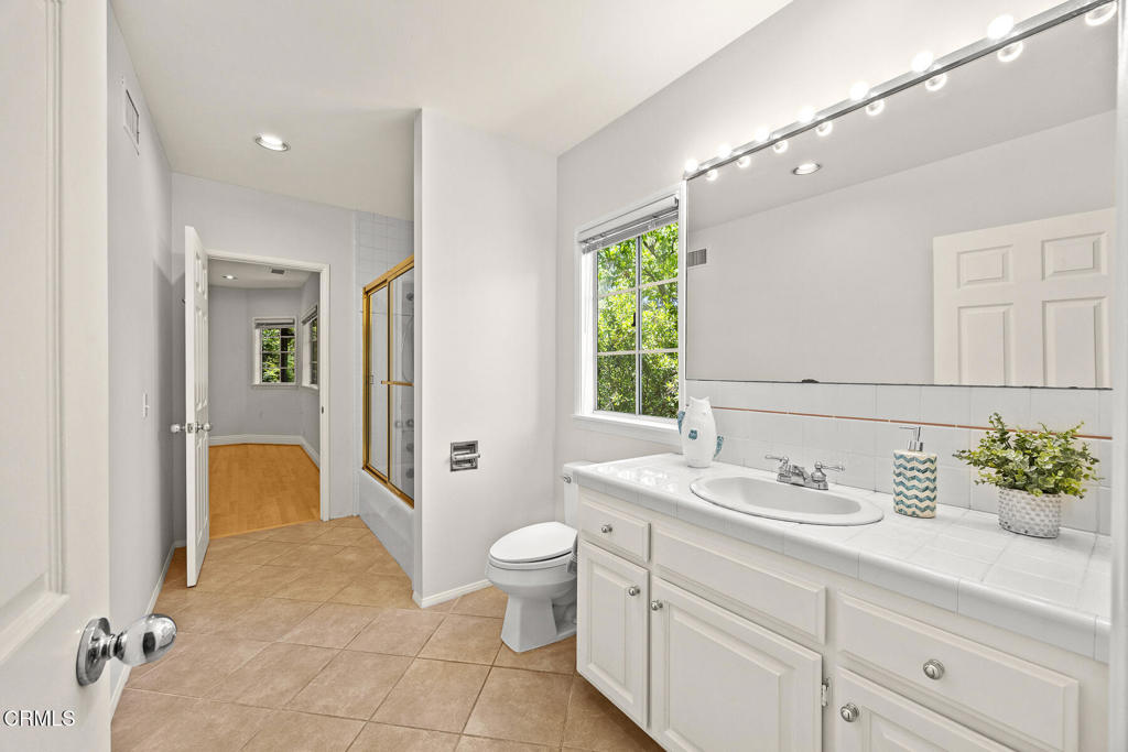 405 Woodcliffe Road Pasadena, CA 91105 - Photo 16 of 24 a bathroom with a sink and a mirror