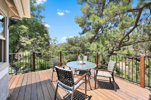 a view of a chairs and table in patio with wooden floor