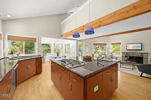 a kitchen with stainless steel appliances granite countertop a stove a sink and a refrigerator