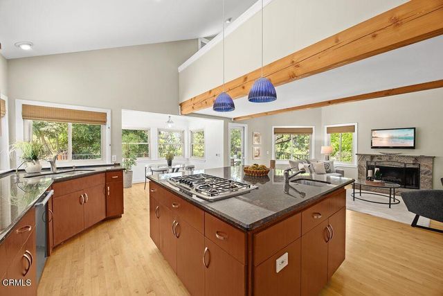 a kitchen with stainless steel appliances granite countertop a stove a sink and a refrigerator