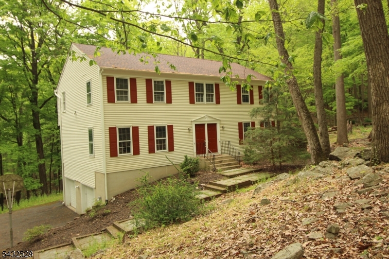 5 Deer Run Drive Randolph, NJ 07869 - Photo 1 of 25 a view of a white house next to a yard with large trees