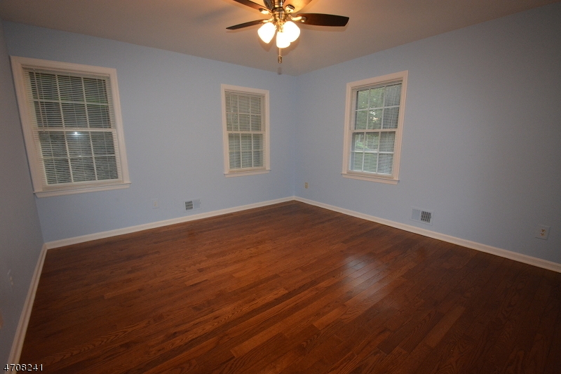 5 Deer Run Drive Randolph, NJ 07869 - Photo 17 of 25 an empty room with wooden floor and windows