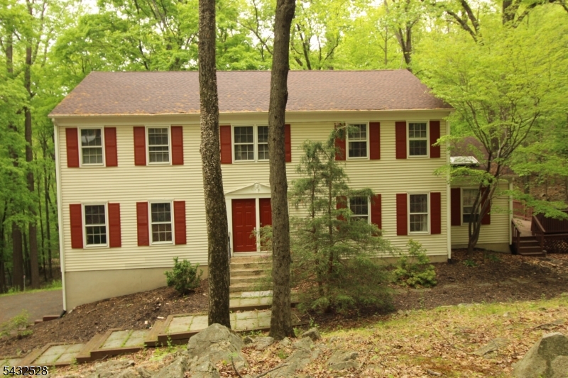 5 Deer Run Drive Randolph, NJ 07869 - Photo 2 of 25 a front view of a house with a yard and trees