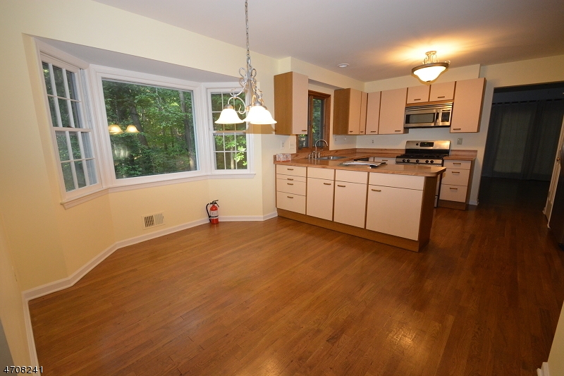 5 Deer Run Drive Randolph, NJ 07869 - Photo 8 of 25 a kitchen with granite countertop white cabinets and stainless steel appliances