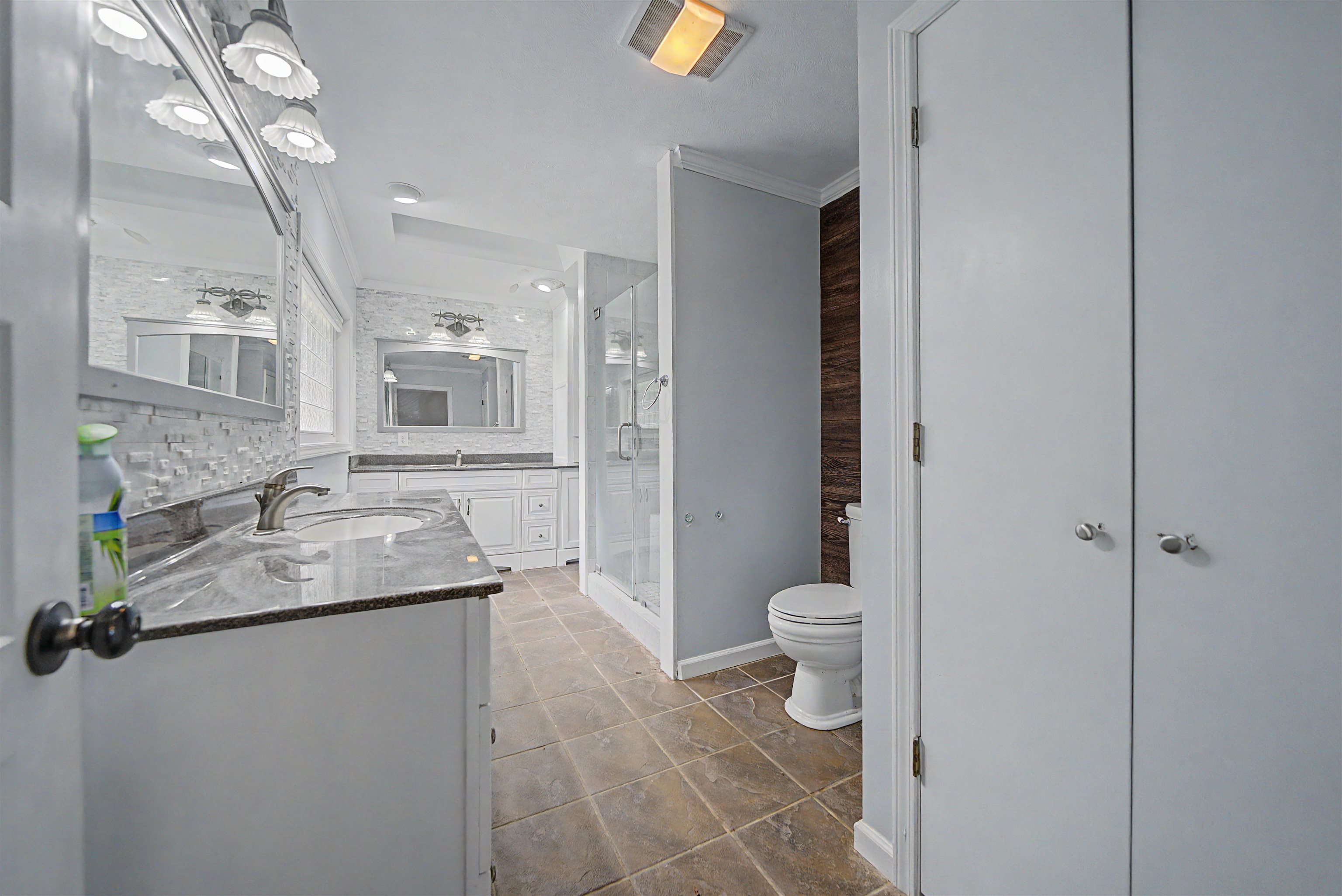 436 Skyline Road Selmer, TN 38375 - Photo 25 of 40 Spacious bathroom featuring a dual vanity with granite countertops, undermount sinks, and chrome faucets