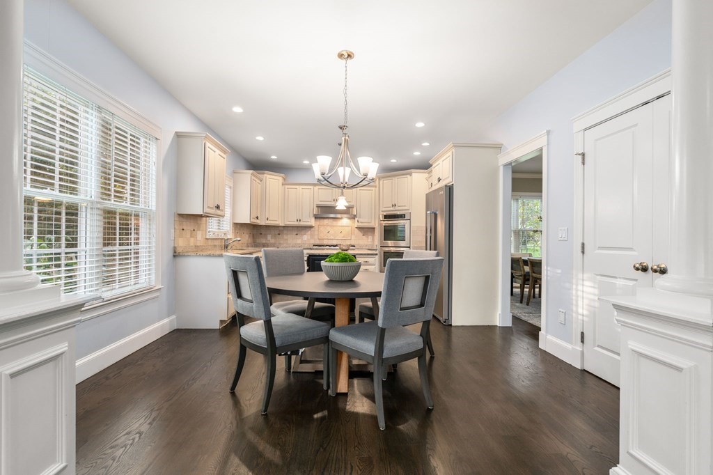 29 Smith Street Needham, MA 02492 - Photo 11 of 31 a view of a dining room and livingroom with furniture wooden floor a chandelier