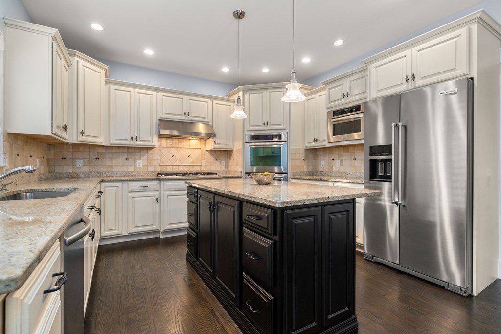29 Smith Street Needham, MA 02492 - Photo 12 of 31 a kitchen with kitchen island granite countertop a sink appliances cabinets and counter space