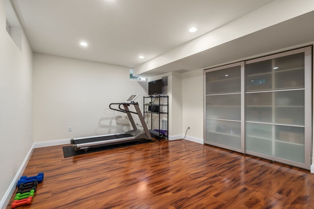 29 Smith Street Needham, MA 02492 - Photo 25 of 31 a view of an empty room with wooden floor and a window