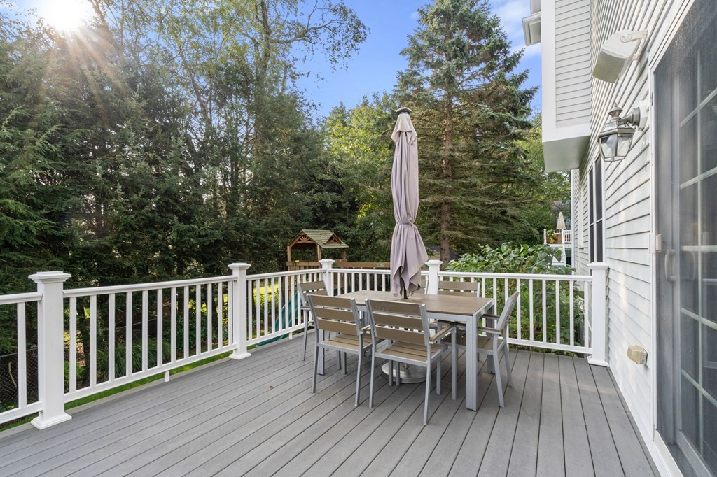 29 Smith Street Needham, MA 02492 - Photo 28 of 31 a view of a deck with a table and chairs with wooden floor and fence