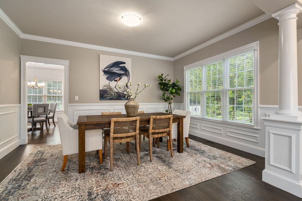 29 Smith Street Needham, MA 02492 - Photo 6 of 31 a dining room with furniture wooden floor a rug and a painting