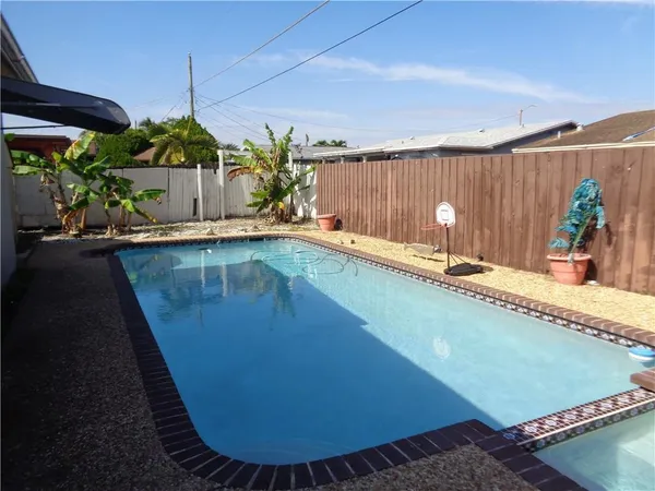 a view of a swimming pool and outdoor seating