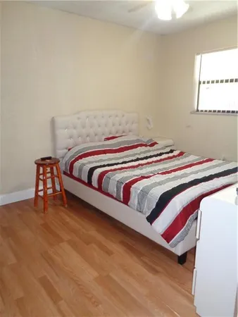 a bedroom with a bed and a lamp