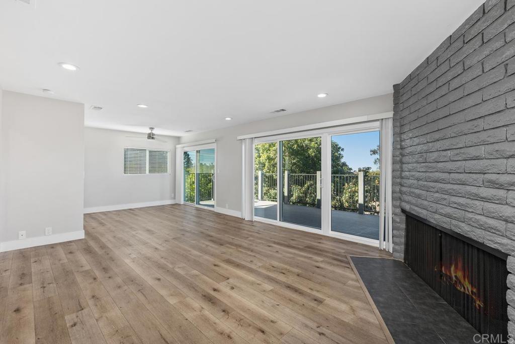 1134 Montura Road, Unit MAIN HOUSE San Marcos, CA 92078 - Photo 11 of 31 a view of an empty room with wooden floor and a fireplace