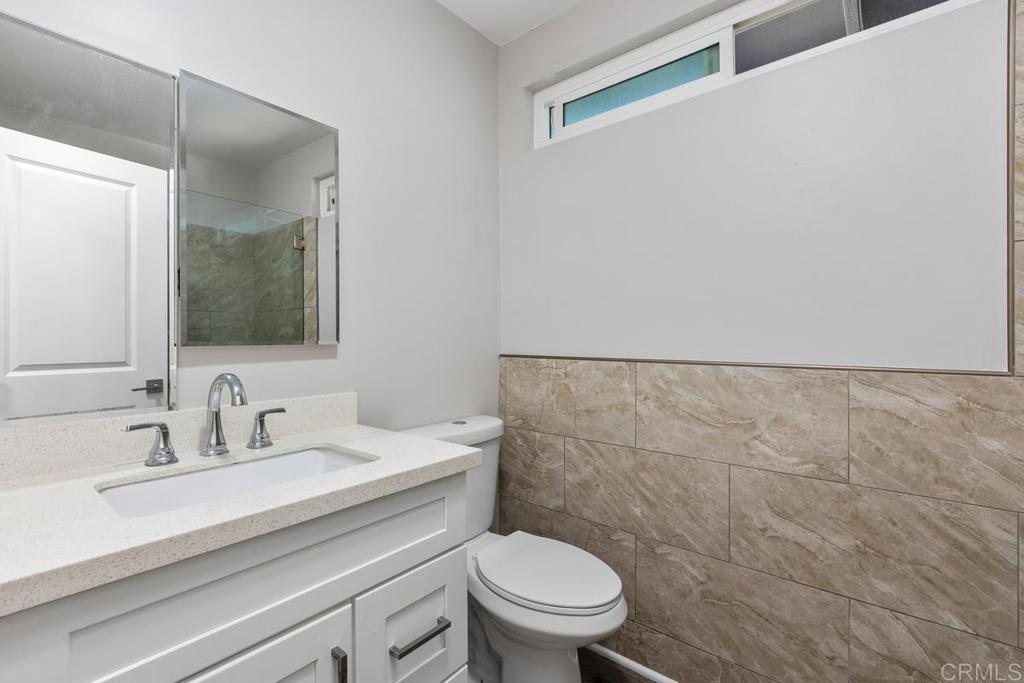 1134 Montura Road, Unit MAIN HOUSE San Marcos, CA 92078 - Photo 18 of 31 a bathroom with a sink a toilet and mirror