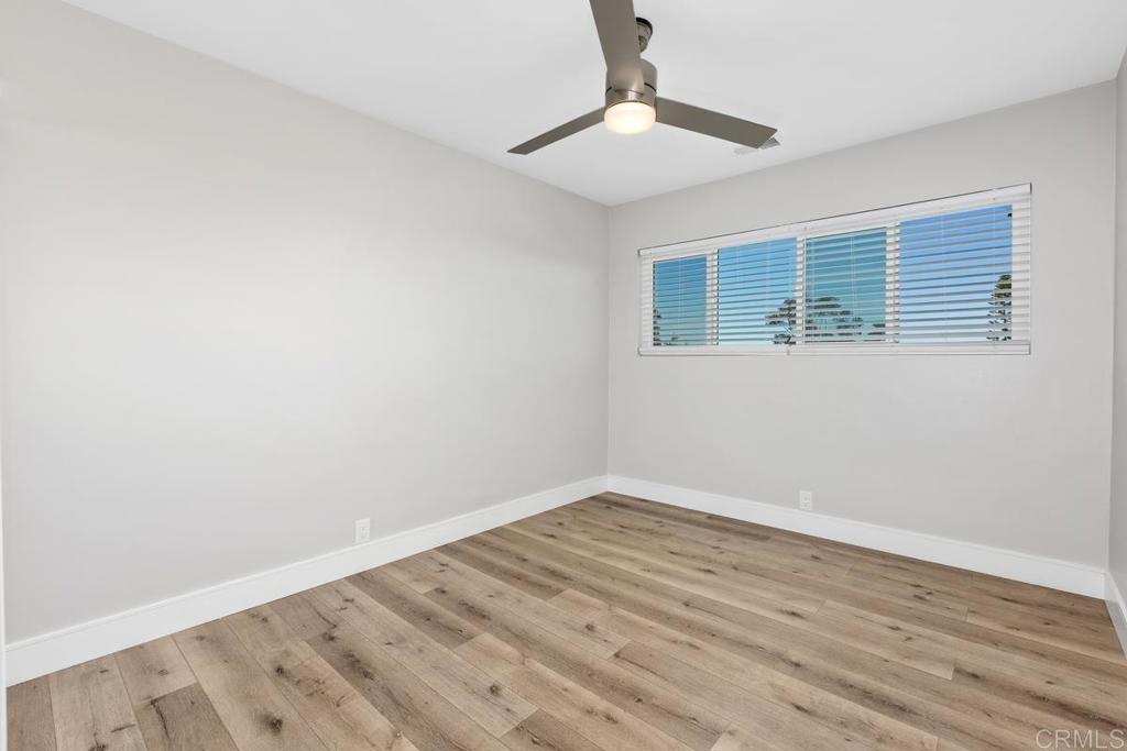1134 Montura Road, Unit MAIN HOUSE San Marcos, CA 92078 - Photo 19 of 31 a view of an empty room with wooden floor and a window