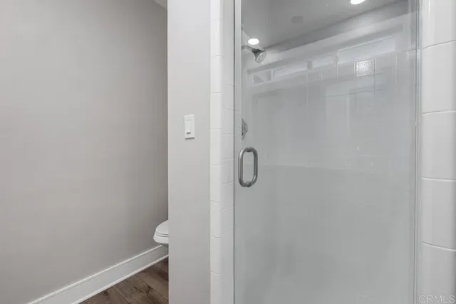 a bathroom with a glass shower door