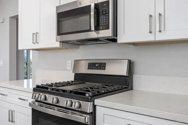 a stove top oven sitting inside of a kitchen
