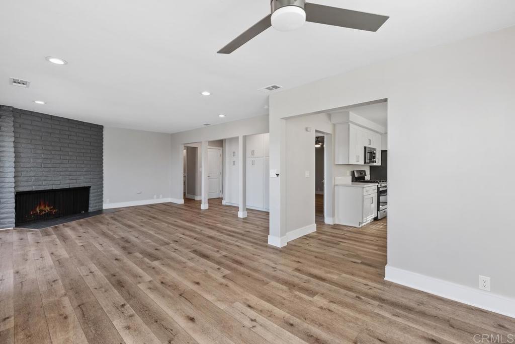 1134 Montura Road, Unit MAIN HOUSE San Marcos, CA 92078 - Photo 5 of 31 a view of empty room with wooden floor and fireplace