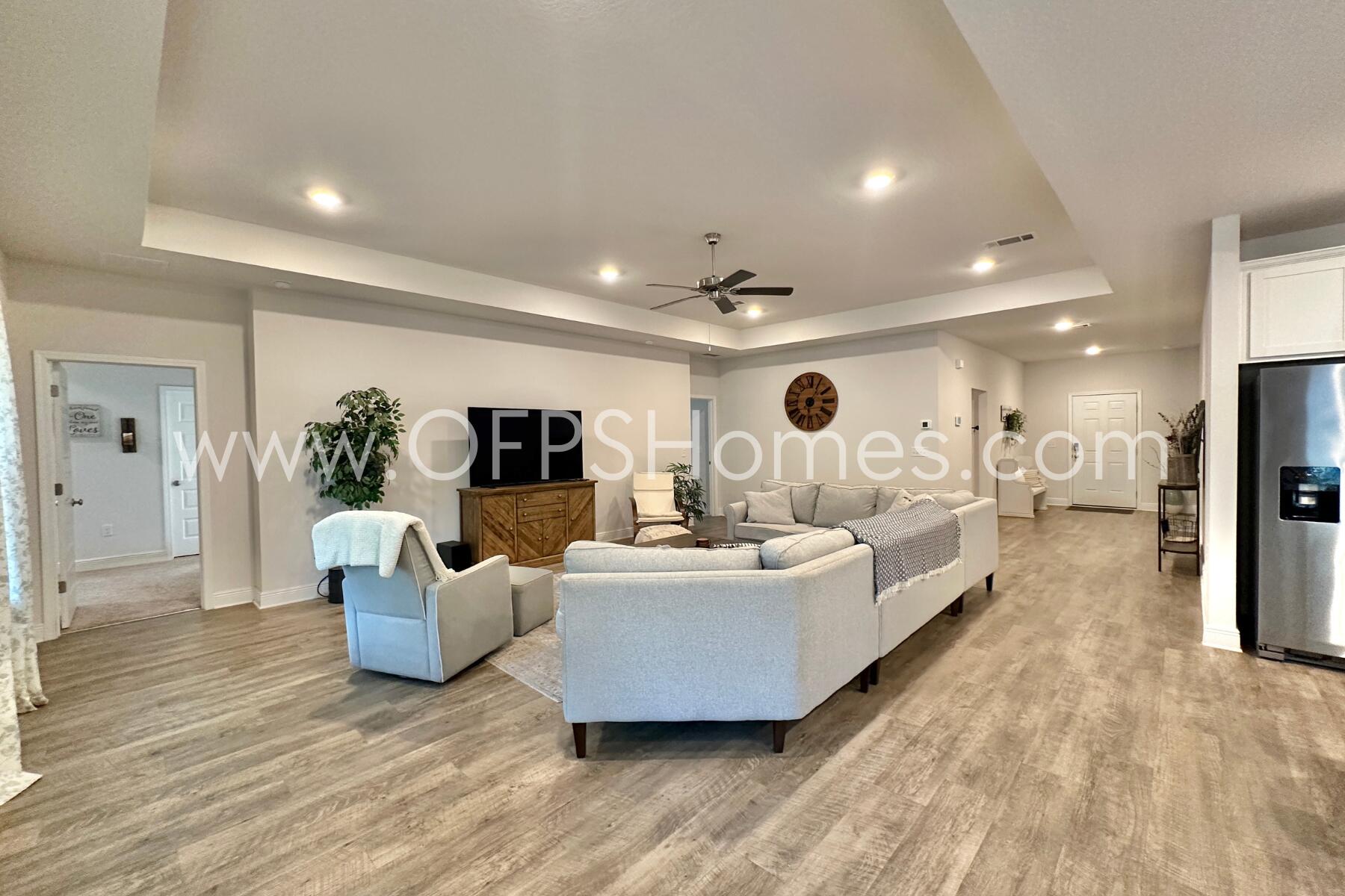 8090 Silver Maple Drive Milton, FL 32583 - Photo 11 of 42 a living room with furniture and a flat screen tv