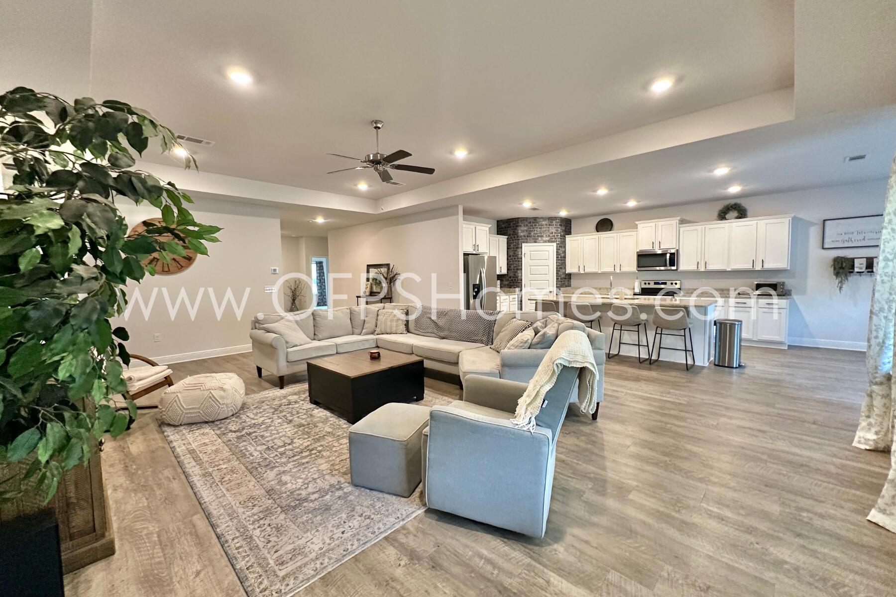 8090 Silver Maple Drive Milton, FL 32583 - Photo 13 of 42 a living room with fireplace furniture and a potted plant