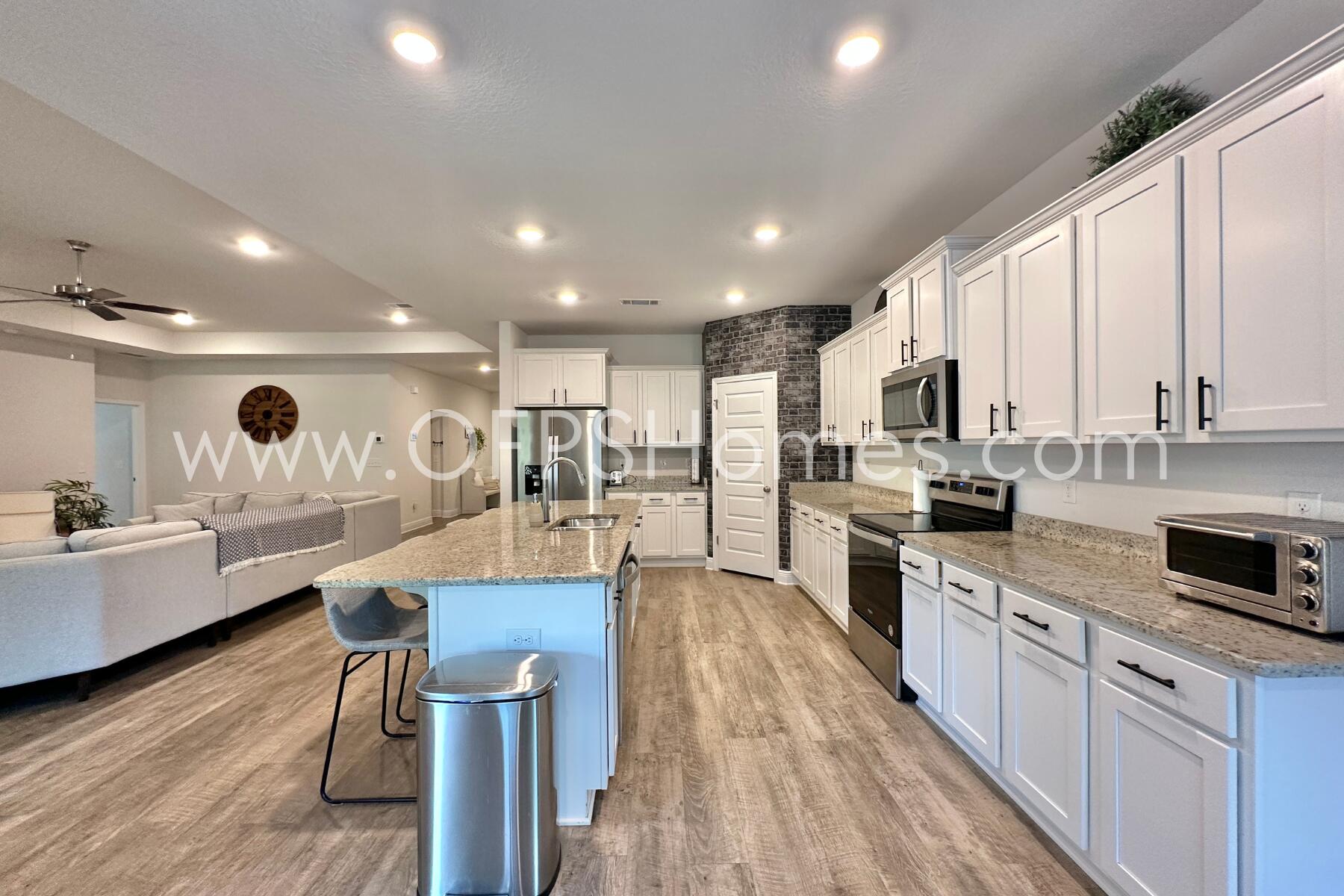 8090 Silver Maple Drive Milton, FL 32583 - Photo 17 of 42 a large kitchen with stainless steel appliances lots of counter space and a sink