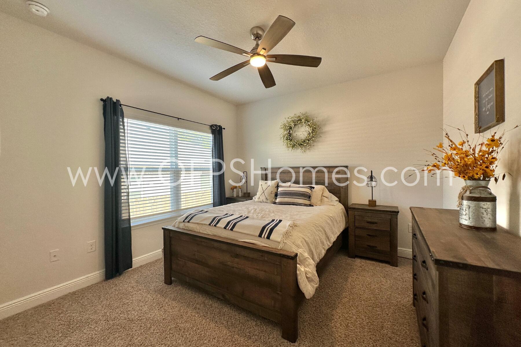 8090 Silver Maple Drive Milton, FL 32583 - Photo 23 of 42 a bedroom with bed and a table
