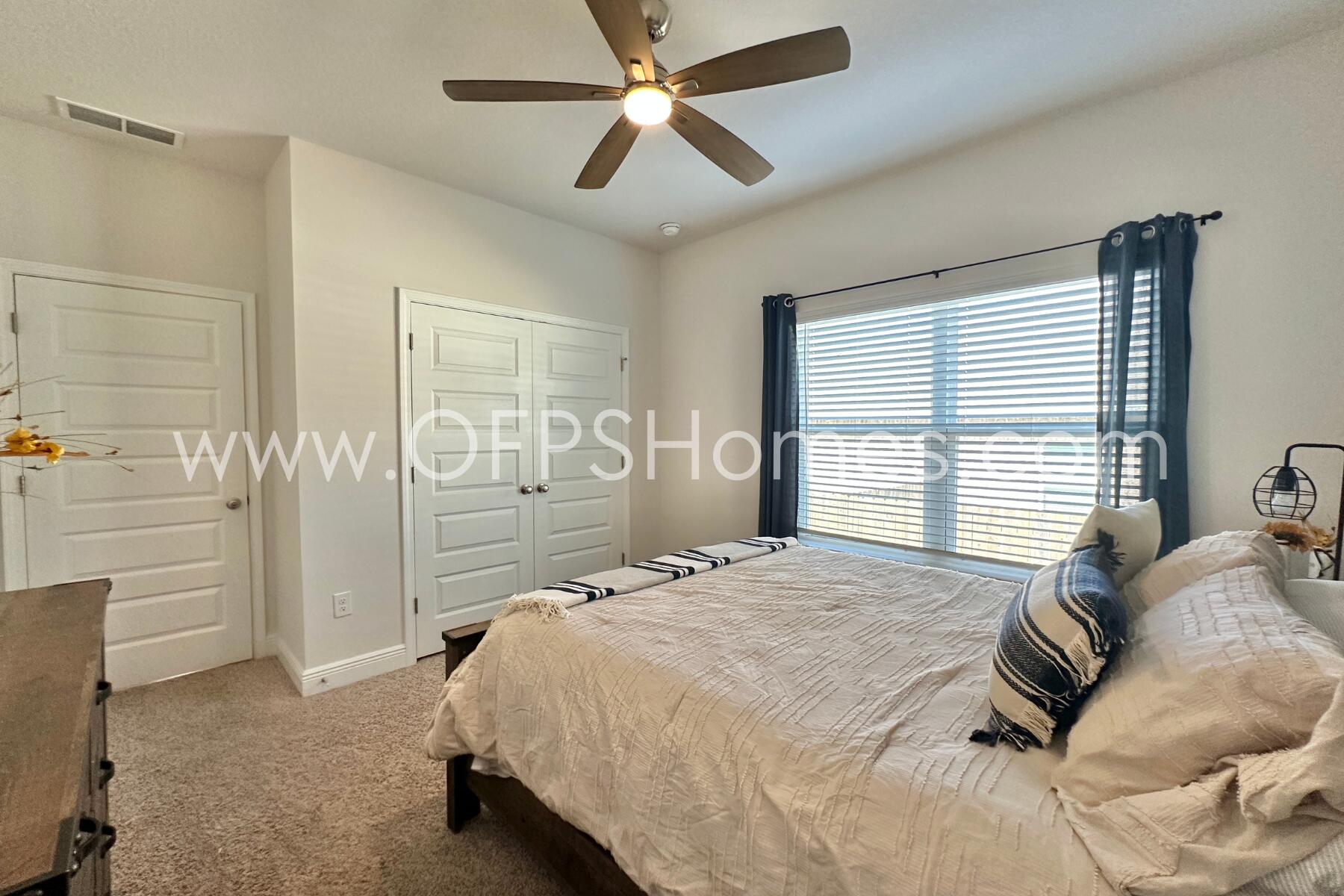 8090 Silver Maple Drive Milton, FL 32583 - Photo 24 of 42 a bedroom with a bed and a chandelier