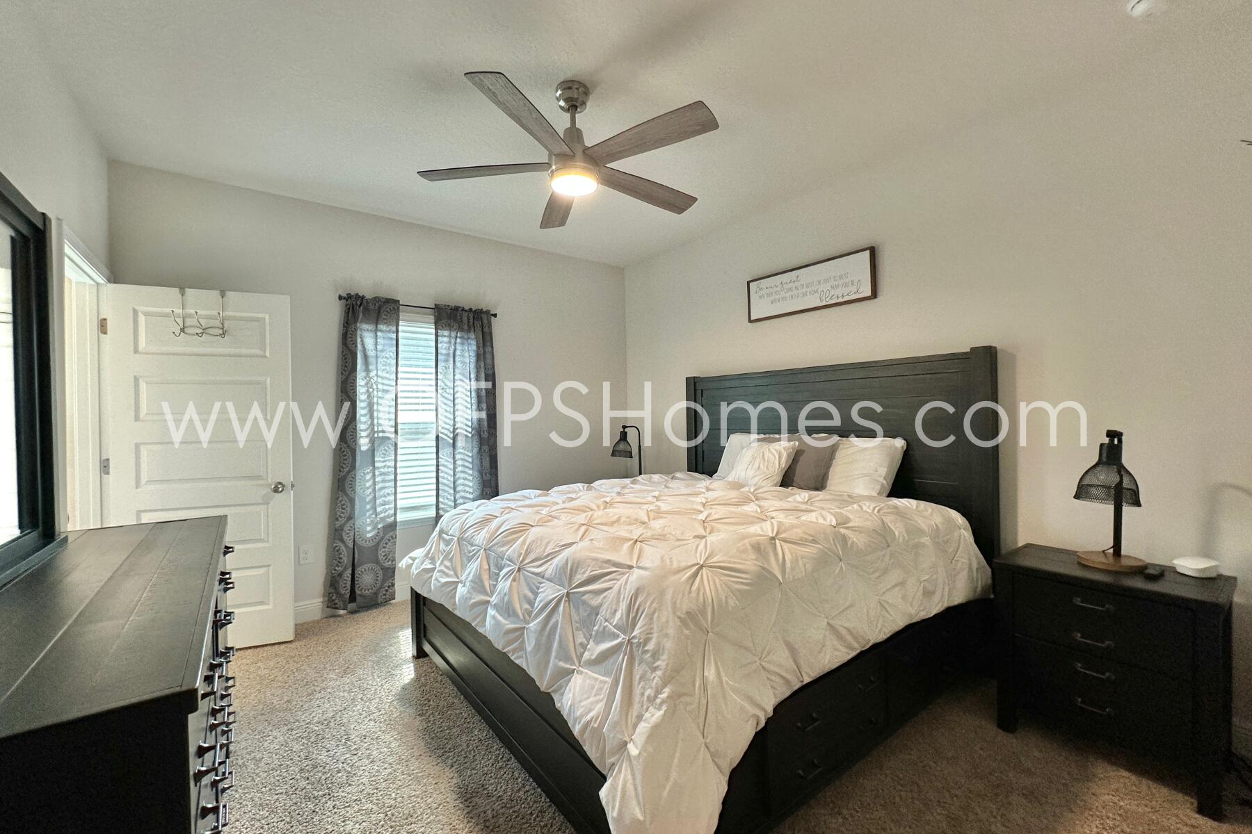 8090 Silver Maple Drive Milton, FL 32583 - Photo 27 of 42 a bedroom with a bed and a chandelier