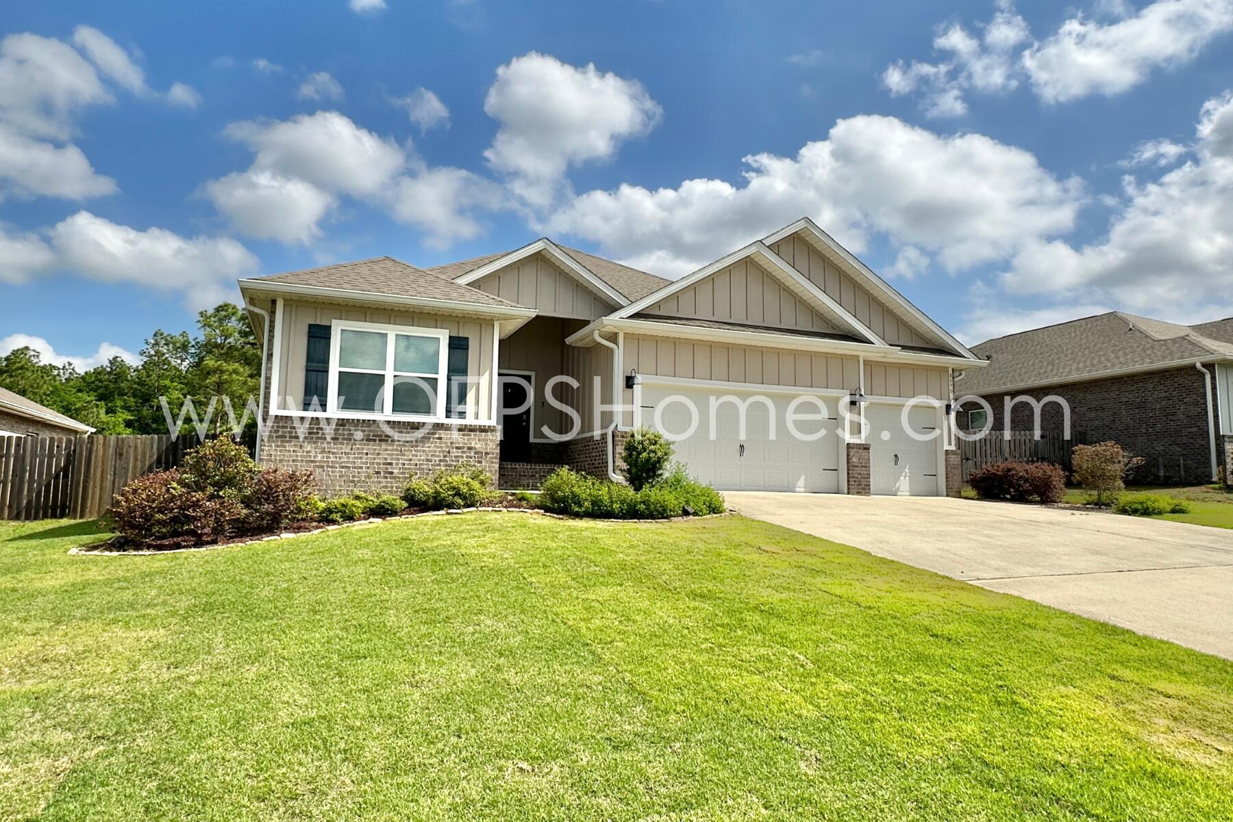 8090 Silver Maple Drive Milton, FL 32583 - Photo 3 of 42 a front view of a house with a yard and garage