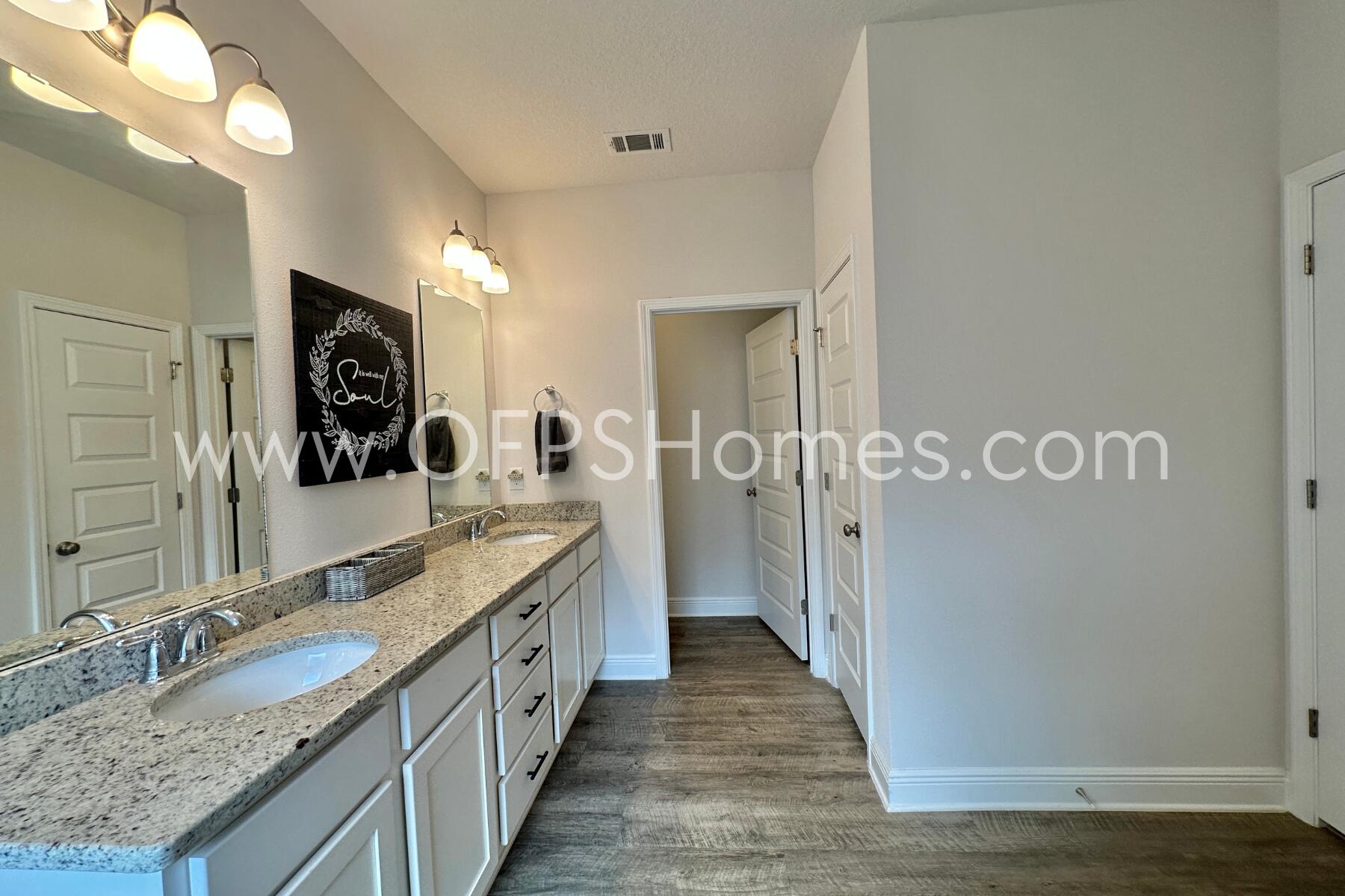 8090 Silver Maple Drive Milton, FL 32583 - Photo 37 of 42 a large bathroom with a granite countertop double vanity and a large mirror