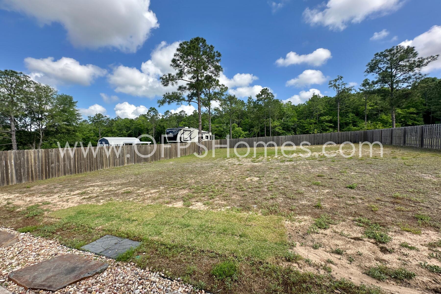 8090 Silver Maple Drive Milton, FL 32583 - Photo 41 of 42 a view of a lake with houses in the back