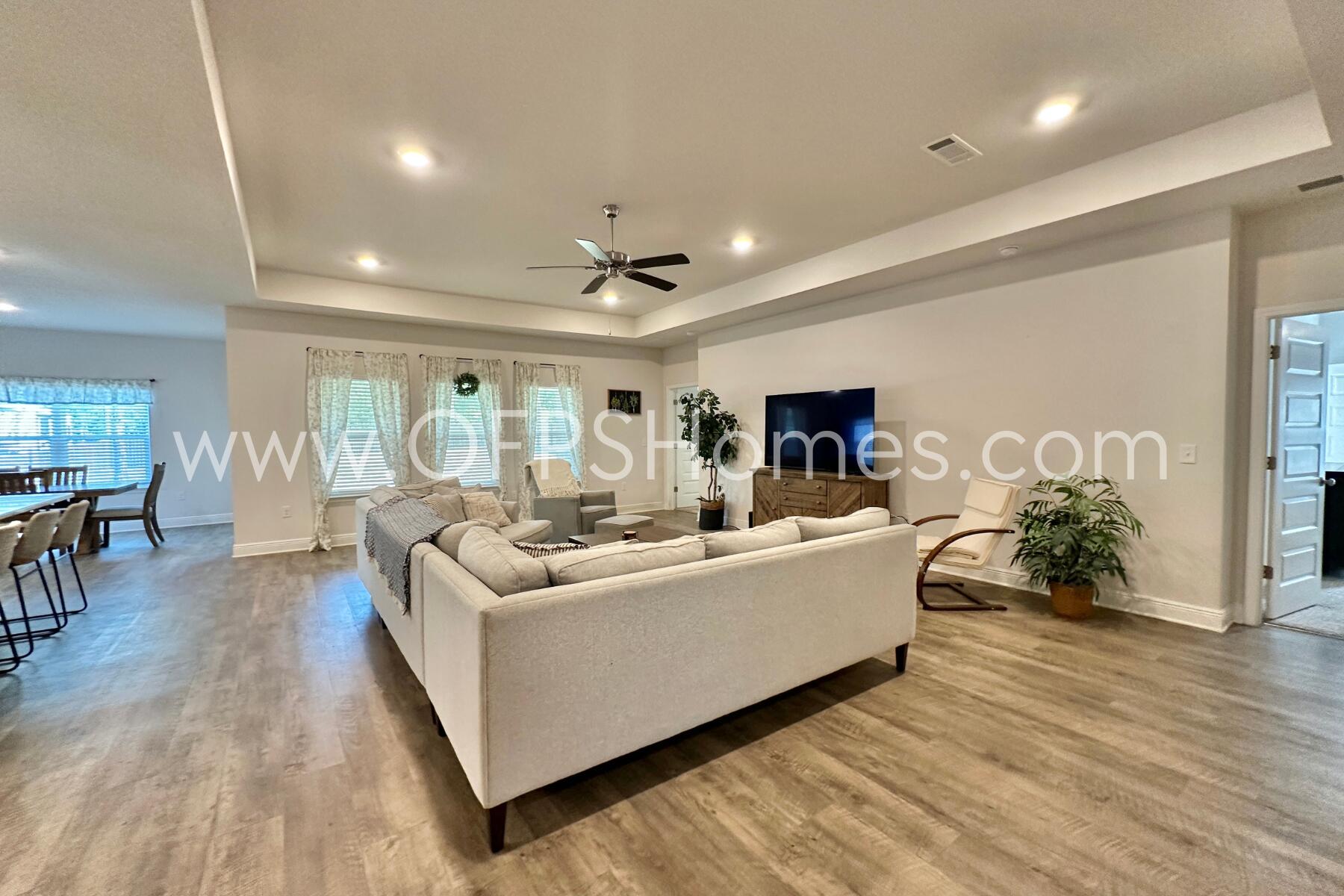 8090 Silver Maple Drive Milton, FL 32583 - Photo 8 of 42 a living room with furniture and a flat screen tv