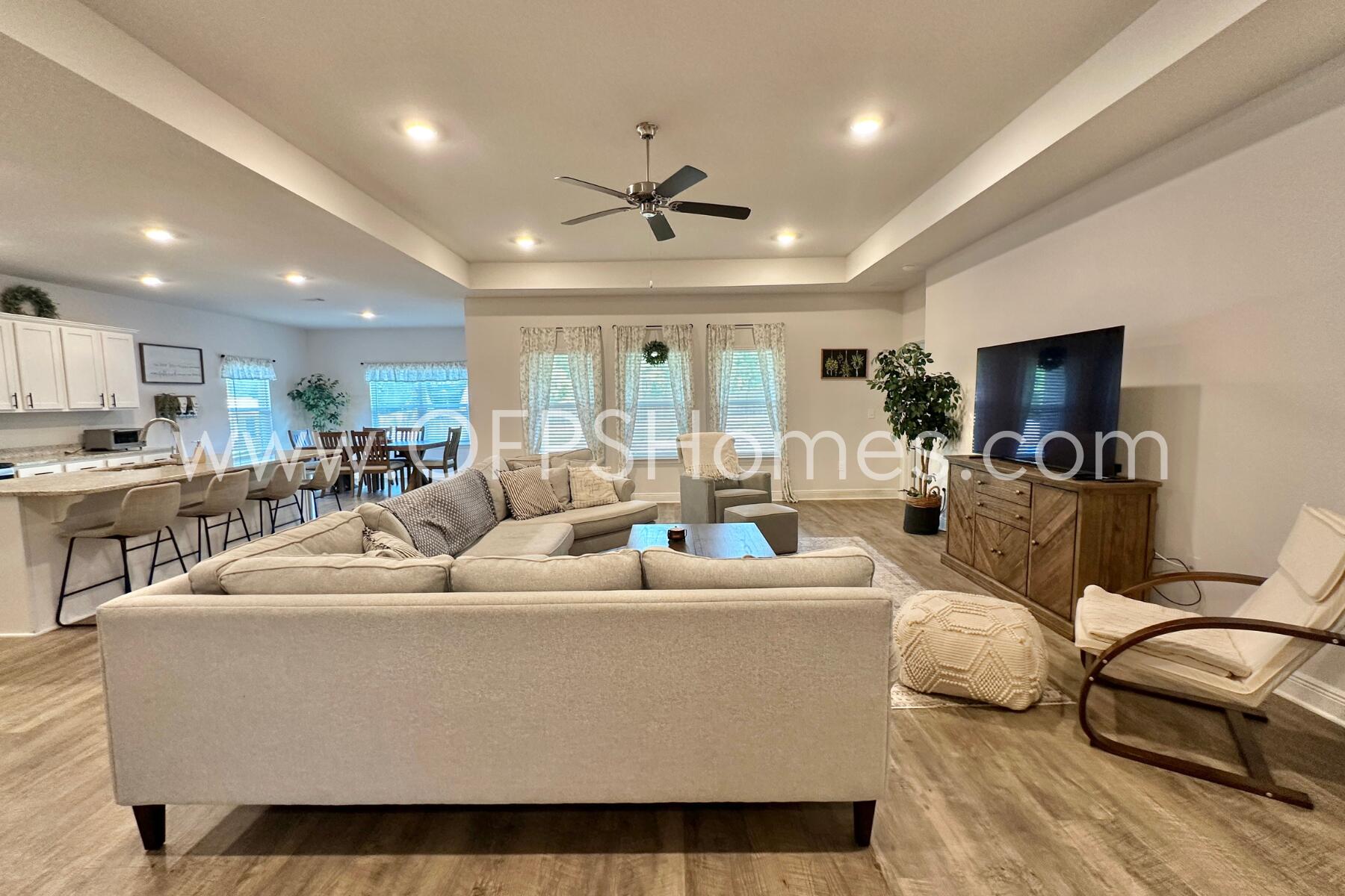 8090 Silver Maple Drive Milton, FL 32583 - Photo 9 of 42 a living room with furniture kitchen view and a large window