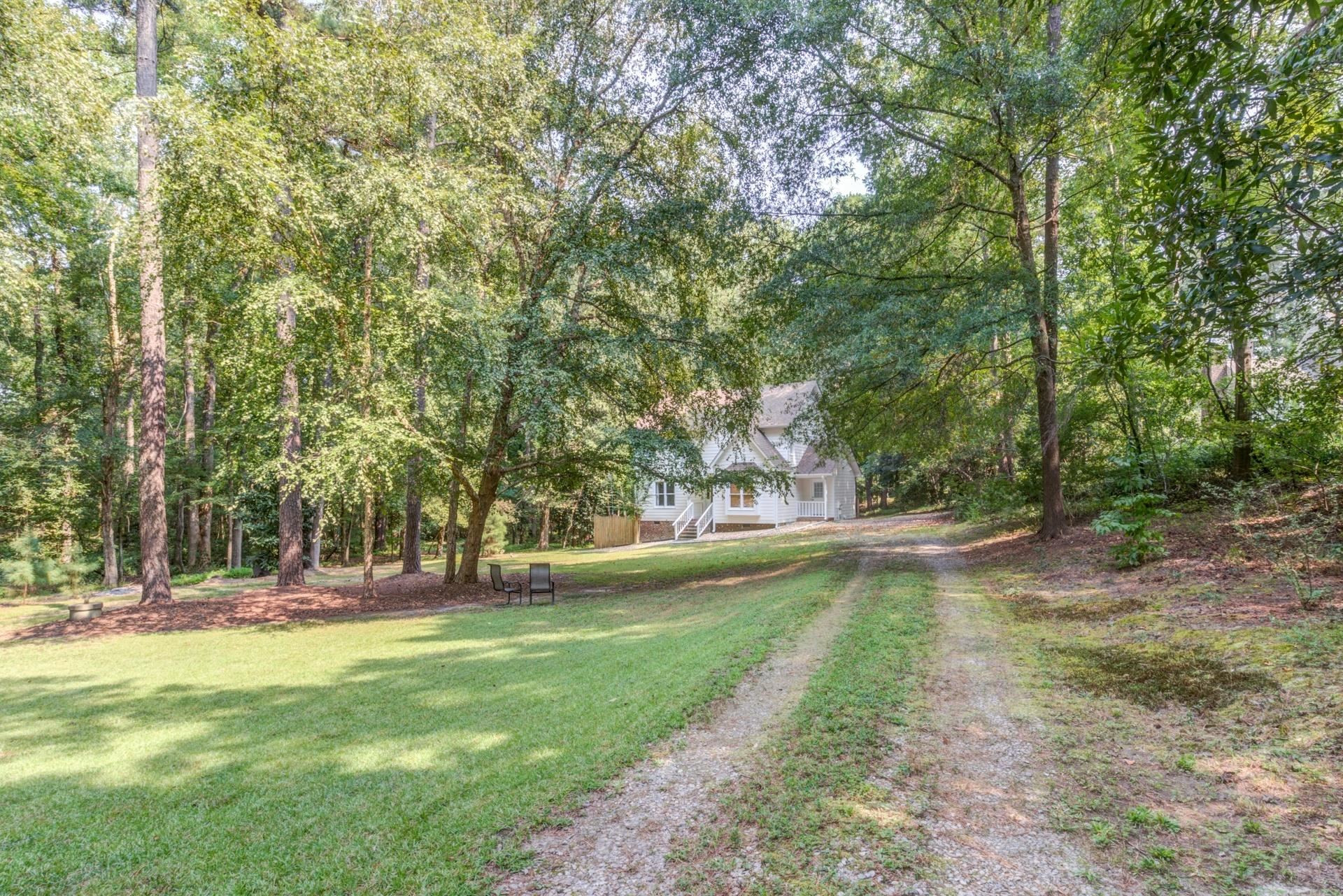 3240 Cornwallis Road Garner, NC 27529 - Photo 3 of 30 The home is set far back on the 1.34 acre property at the curve of the convenient horseshoe driveway.