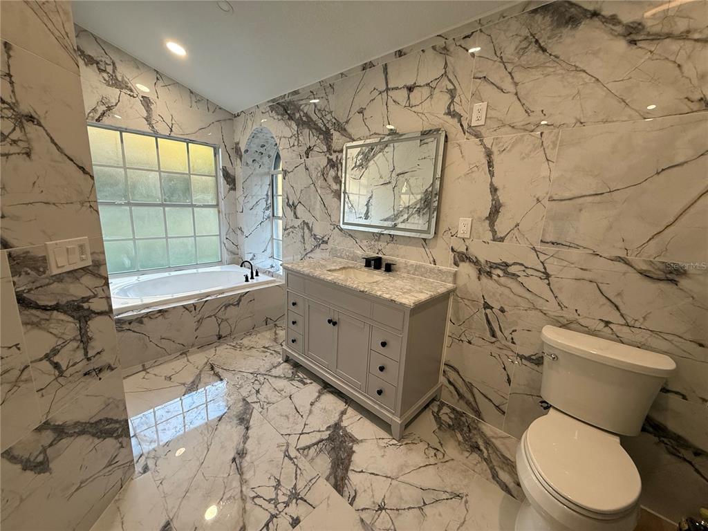 14273 Nugent Circle Spring Hill, FL 34609 - Photo 17 of 27 a bathroom with a toilet sink and shower