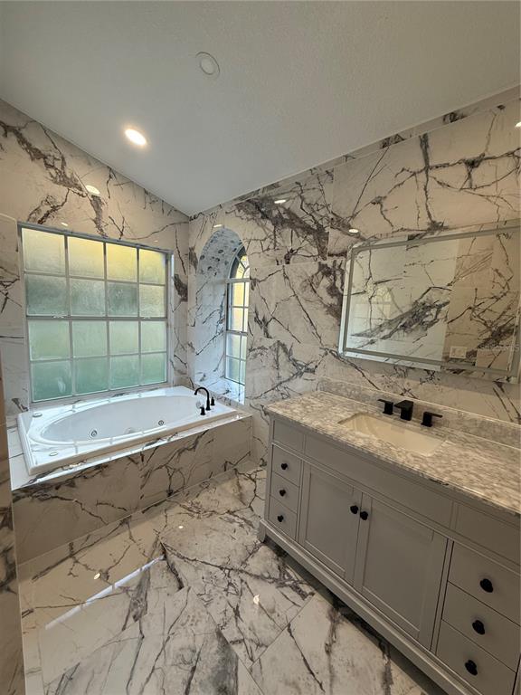 14273 Nugent Circle Spring Hill, FL 34609 - Photo 18 of 27 a bathroom with a granite countertop sink mirror and shower