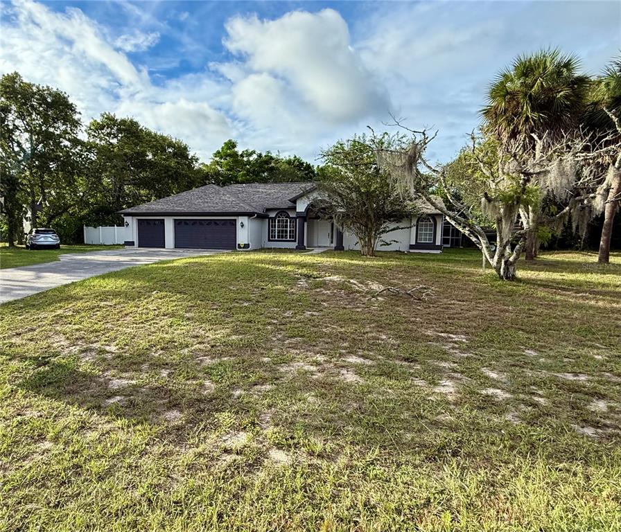 14273 Nugent Circle Spring Hill, FL 34609 - Photo 2 of 27 a front view of a house with a yard