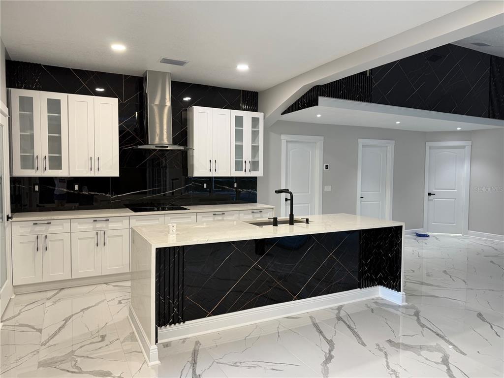 14273 Nugent Circle Spring Hill, FL 34609 - Photo 5 of 27 a spacious bathroom with a double vanity sink and mirror