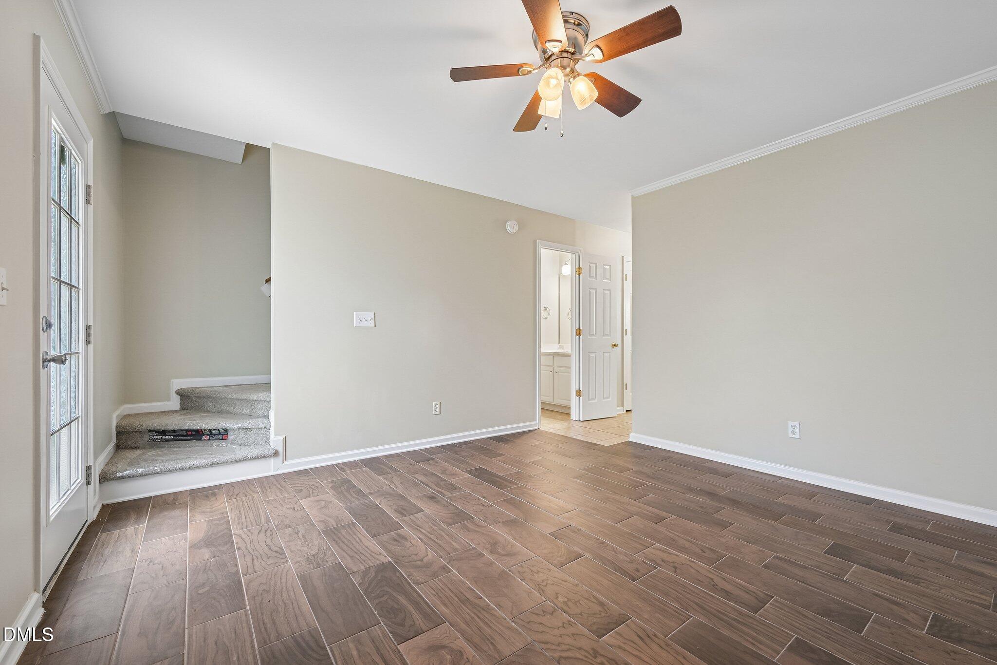 278 South Raleigh Street Angier, NC 27501 - Photo 15 of 35 an empty room with wooden floor fan and windows
