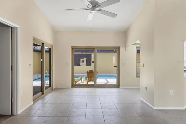 a view of a hallway with a chandelier and living room