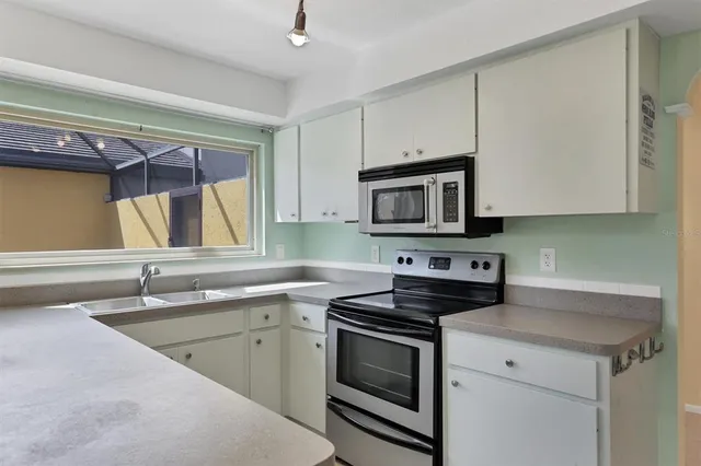 a kitchen with a sink stove and microwave