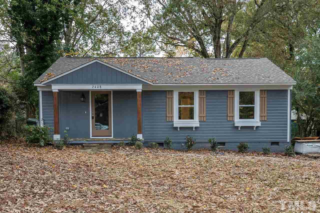 2408 Milburnie Road Raleigh, NC 27610 - Photo 2 of 25 a front view of a house with garden