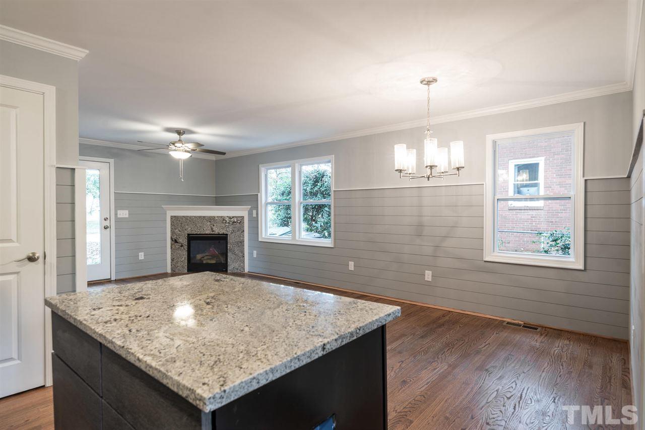 2408 Milburnie Road Raleigh, NC 27610 - Photo 14 of 25 an empty room with windows and fireplace