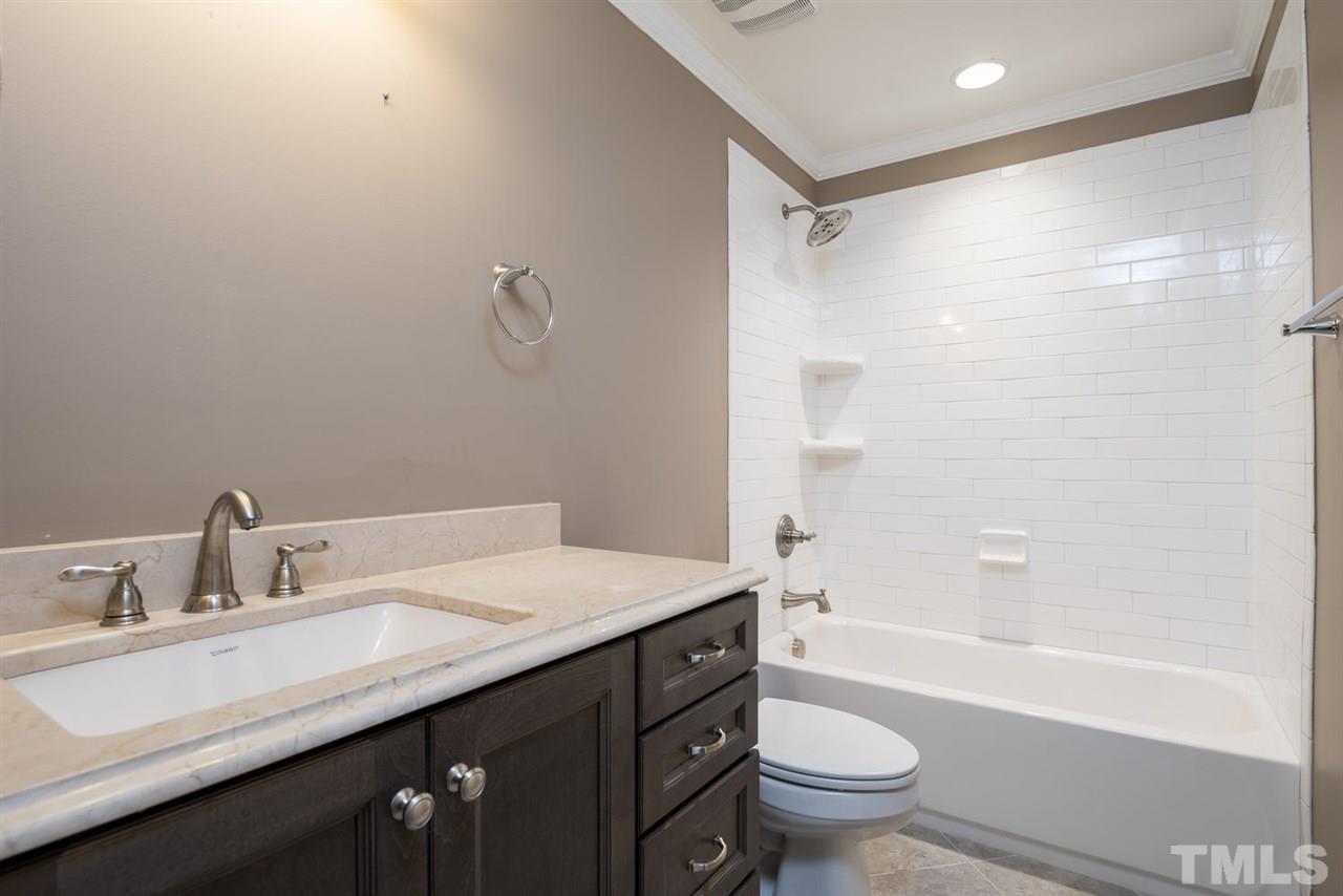 2408 Milburnie Road Raleigh, NC 27610 - Photo 15 of 25 a bathroom with a granite countertop sink toilet and shower