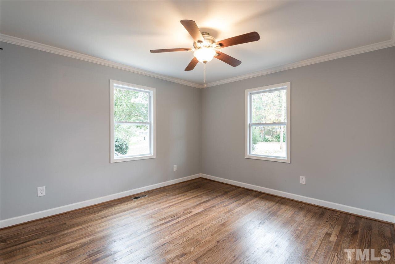 2408 Milburnie Road Raleigh, NC 27610 - Photo 18 of 25 a view of an empty room with wooden floor and a window