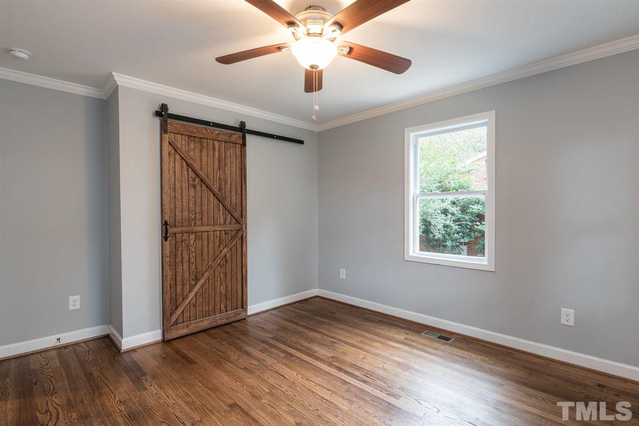 2408 Milburnie Road Raleigh, NC 27610 - Photo 19 of 25 wooden floor in an empty room with a window