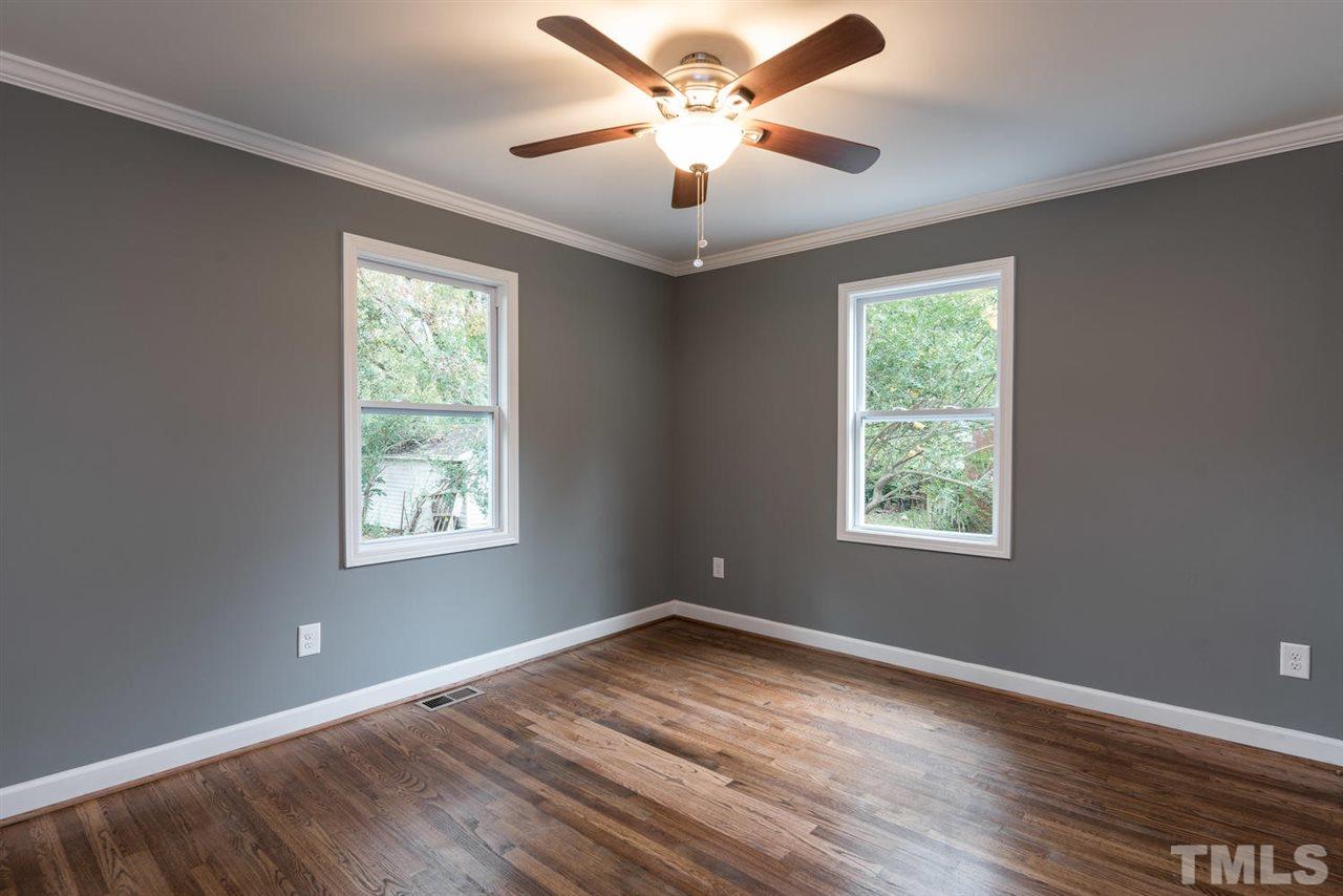 2408 Milburnie Road Raleigh, NC 27610 - Photo 20 of 25 a view of an empty room with wooden floor and a window